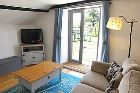 Field View Cottage - french doors in lounge leading on to garden
